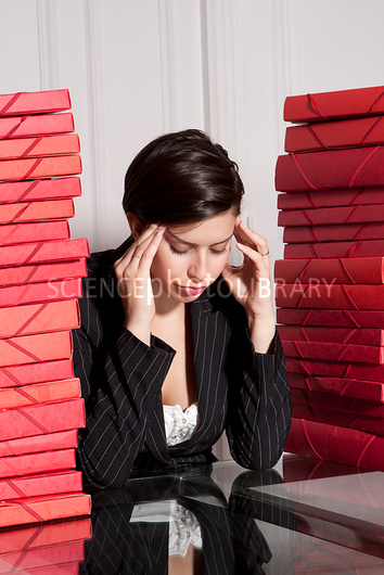 Businesswoman with stacks of folders
